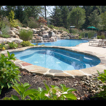 FREE FORM POOL WITH SEPARATE SPA WITH WATER FALL AND NATURAL STONE COPING