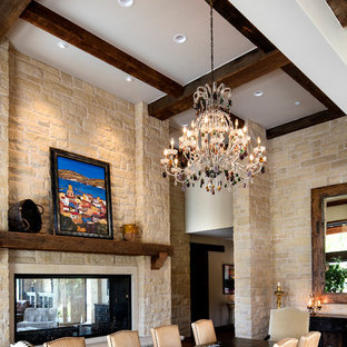 ウィチタの広いラスティックスタイルのLDKの画像 (ベージュの壁、濃色無垢フローリング、両方向型暖炉、石材の暖炉まわり)