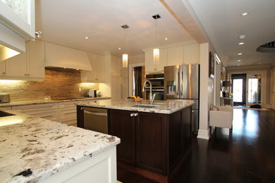 This is an example of a traditional u-shaped separate kitchen in Toronto with shaker cabinets, beige cabinets, beige splashback, stainless steel appliances, dark hardwood floors and with island.