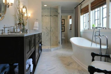 Inspiration for a large traditional bathroom in Other with shaker cabinets, black cabinets, a freestanding tub, a corner shower, stone tile, grey walls, marble floors and marble benchtops.