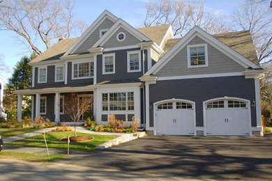 Example of a large classic multicolored three-story wood gable roof design in Denver
