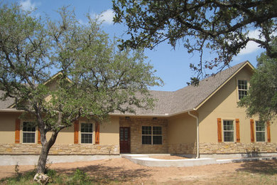 Mid-sized traditional beige two-story mixed siding exterior home idea in Austin