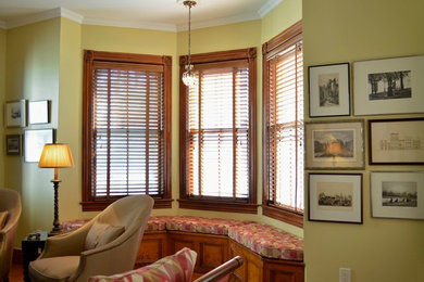 Inspiration for a large eclectic enclosed medium tone wood floor family room remodel in New York with yellow walls and no tv