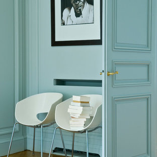 Photo of a mid-sized eclectic front door in Paris with blue walls, light hardwood floors, a single front door, a blue front door and beige floor.