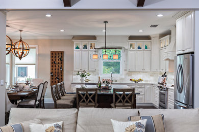 Mid-sized transitional l-shaped open concept kitchen photo in Miami with an undermount sink, raised-panel cabinets, white cabinets, quartz countertops, white backsplash, porcelain backsplash, stainless steel appliances and an island