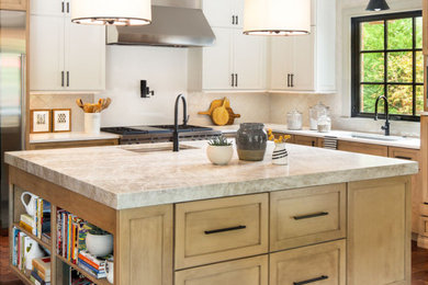 Mid-sized transitional l-shaped brown floor and dark wood floor open concept kitchen photo in St Louis with an undermount sink, light wood cabinets, quartzite countertops, beige backsplash, ceramic backsplash, stainless steel appliances, an island, gray countertops and shaker cabinets