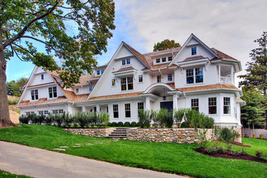Inspiration for a huge timeless white three-story wood house exterior remodel in New York