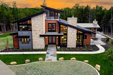 Inspiration for a large contemporary orange three-story concrete fiberboard and shingle house exterior remodel in Chicago with a shed roof, a metal roof and a gray roof