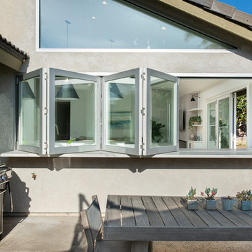 AG BiFold Patio Door & Window Pairing Connects All-White Kitchen to the Outdoors