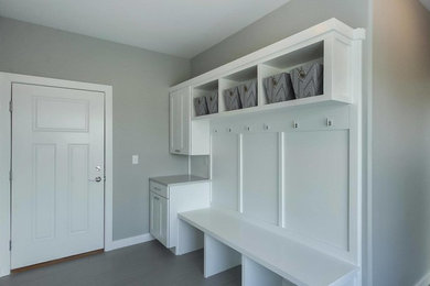 Inspiration for a small timeless porcelain tile and gray floor entryway remodel in Cedar Rapids with gray walls and a white front door