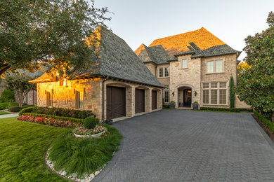 Design ideas for a large transitional front yard full sun driveway for summer in Dallas with brick pavers.