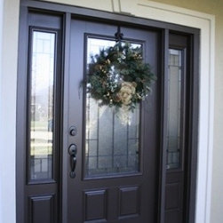 Black Front Door with Glass Work & Unique White Doorway Trim - Front Doors