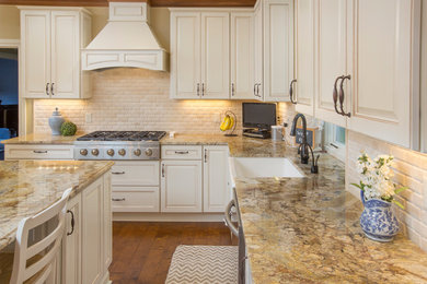 Large elegant l-shaped dark wood floor eat-in kitchen photo in Columbus with a farmhouse sink, raised-panel cabinets, white cabinets, granite countertops, white backsplash, subway tile backsplash, stainless steel appliances and an island