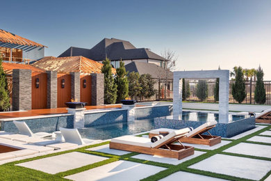 Pool - large modern backyard concrete paver and rectangular pool idea in Dallas