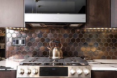 Example of a large trendy l-shaped medium tone wood floor and brown floor eat-in kitchen design in DC Metro with an undermount sink, flat-panel cabinets, medium tone wood cabinets, quartzite countertops, metallic backsplash, metal backsplash, stainless steel appliances, an island and multicolored countertops
