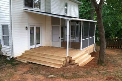 Example of a mid-sized classic backyard deck design in Charleston with a roof extension