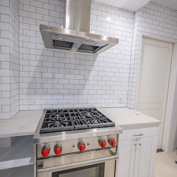 Range and Hood with Open Shelf Cabinet Full Subway Tile Wall