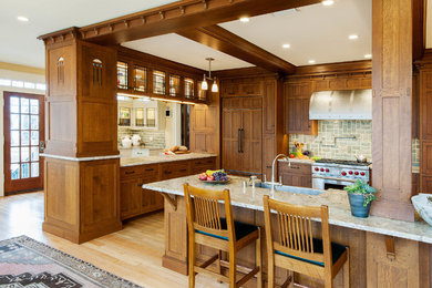 Arts and crafts kitchen in Milwaukee with flat-panel cabinets and medium wood cabinets.