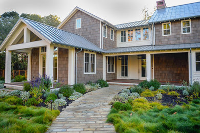 Inspiration for a mid-sized transitional brown two-story wood exterior home remodel in San Francisco with a metal roof