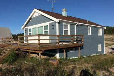 Mid-sized coastal blue two-story wood gable roof idea in Other
