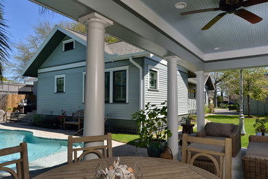 Mid-sized arts and crafts backyard concrete patio photo in Houston with a roof extension
