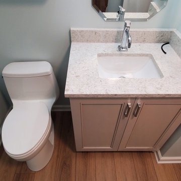 Fiinshed basement half bath, custom quartz countertop, luxury vinyl plank floor.