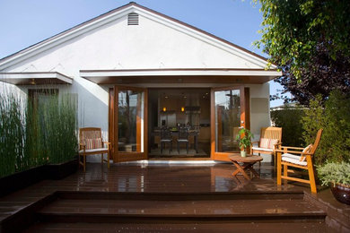 Inspiration for a large timeless backyard deck remodel in Los Angeles with a roof extension