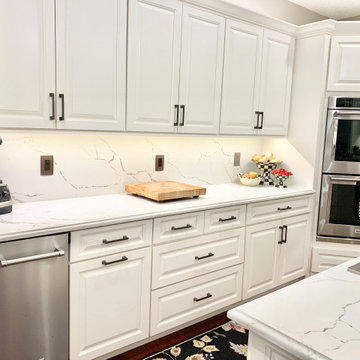 Ivory White Kitchen With Marble Look Quartz Counters and Splash