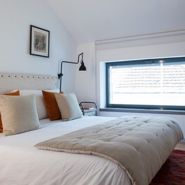 Bedroom with Orange Cushions and Reading Light, Marvila