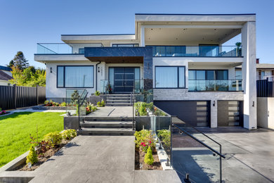 Inspiration for a contemporary white three-story mixed siding exterior home remodel in Vancouver