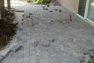 Inspiration for a mid-sized rustic backyard concrete paver patio remodel in Omaha
