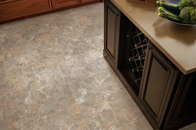 Kitchen - traditional vinyl floor kitchen idea in Other with a drop-in sink, raised-panel cabinets, medium tone wood cabinets, laminate countertops, stainless steel appliances and an island