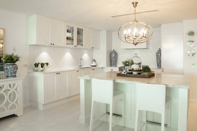 Inspiration for a mid-sized modern l-shaped separate kitchen in Brisbane with shaker cabinets, white cabinets, marble benchtops, white splashback, ceramic splashback, stainless steel appliances, with island, an undermount sink, ceramic floors and white floor.