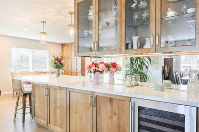 Example of a large country u-shaped brown floor eat-in kitchen design in San Francisco with recessed-panel cabinets, dark wood cabinets, quartz countertops, multicolored backsplash, glass tile backsplash, stainless steel appliances, an island and white countertops