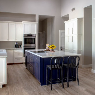 Full kitchen remodel with white cabinets and blue kitchen island