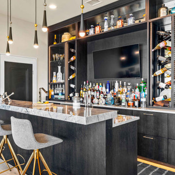 Home Bar with Marble Countertop and Dark Cabinetry