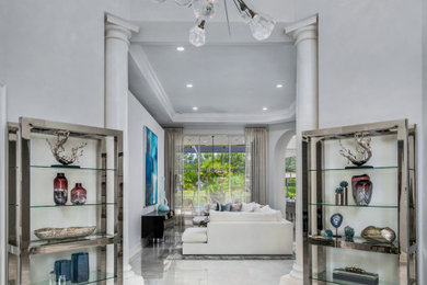 Large contemporary foyer in Miami with grey walls, marble floors and grey floor.