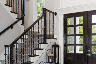 Entryway - large transitional medium tone wood floor entryway idea in Other with gray walls and a dark wood front door