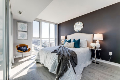 Small trendy master light wood floor and gray floor bedroom photo in Toronto with brown walls