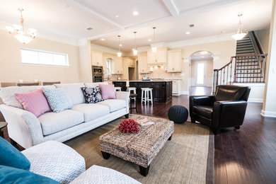 Inspiration for a transitional open concept medium tone wood floor and brown floor family room remodel in Jacksonville with beige walls and a standard fireplace