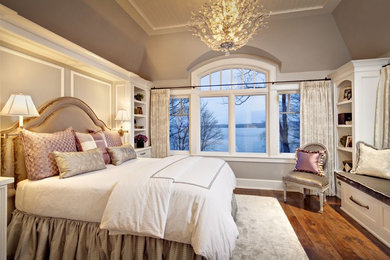 Inspiration for a large timeless master medium tone wood floor bedroom remodel in Milwaukee with beige walls and no fireplace