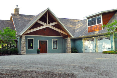 Mid-sized trendy blue two-story mixed siding gable roof photo in Other