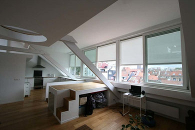 Inspiration for a mid-sized contemporary loft-style family room in Brussels with white walls and light hardwood floors.