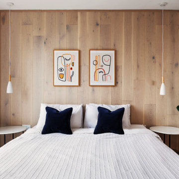 Elegant Main Bedroom with Wood Panel Accent Wall and Blue Accents in Barnet, Lon