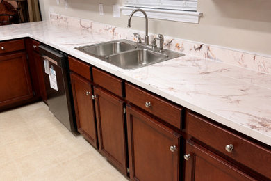 Example of a mid-sized transitional l-shaped eat-in kitchen design in Other with marble countertops, white backsplash, marble backsplash, no island and white countertops
