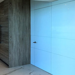 Invisible custom Italian Doors with wall panels and Italian Hardware - Interior Doors