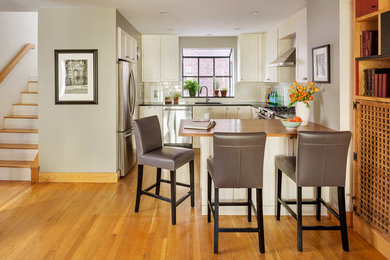 Photo of a contemporary dining room in Boston with grey walls and light hardwood floors.