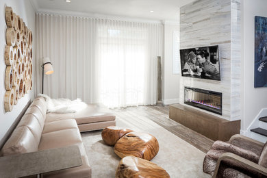 Contemporary open concept family room in Orlando with beige walls, a ribbon fireplace and a wall-mounted tv.