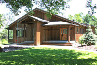 Inspiration for a timeless brown one-story wood exterior home remodel in Other with a shingle roof