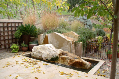 Contemporary backyard patio in San Francisco with a water feature and natural stone pavers.